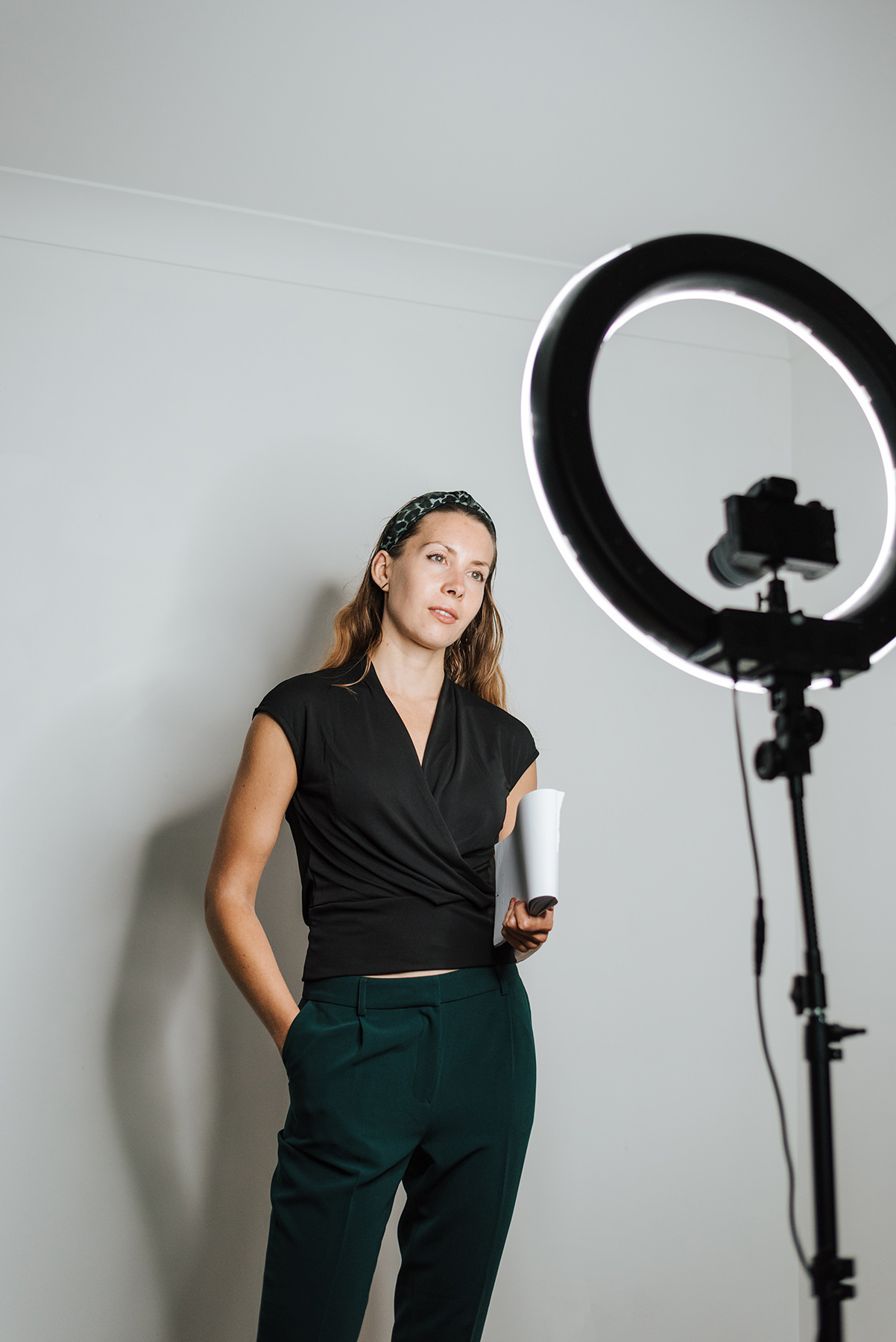 woman filming herself with camera and ring light